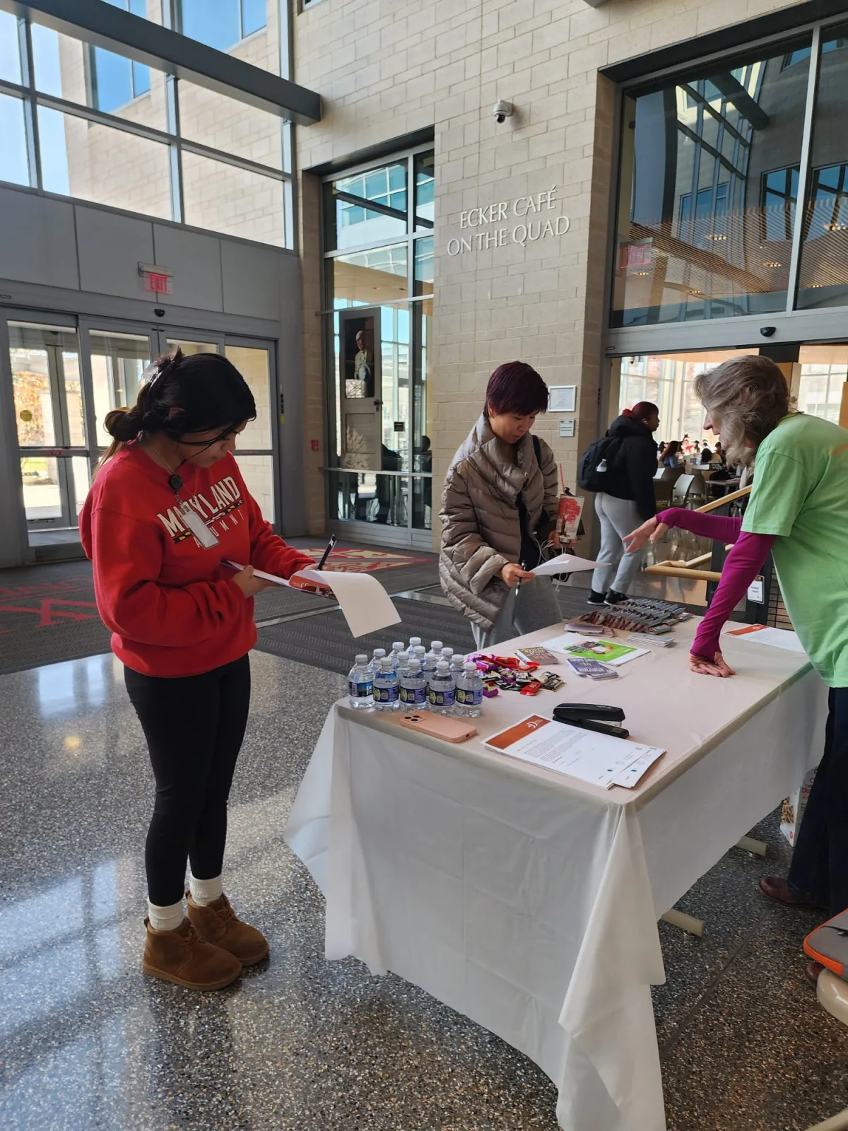 Job fair participants visiting an R1YC information table