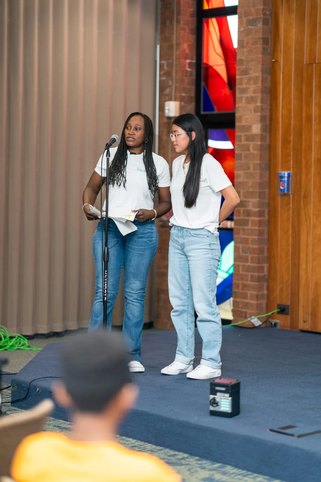 Two young participants presenting to the audience