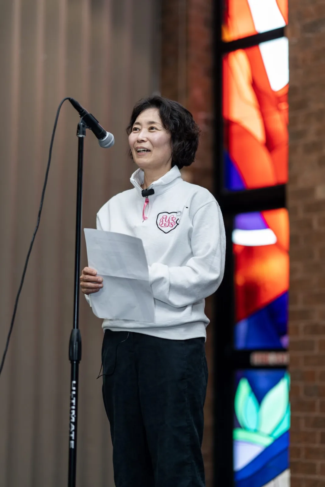 Young participant speaking at a microphone